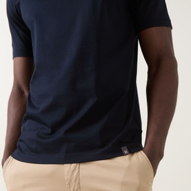 Model wearing Boggi Milano Solid Logo T-Shirt in navy blue, round neckline, short sleeves, logo tab detail, styled with beige chinos.