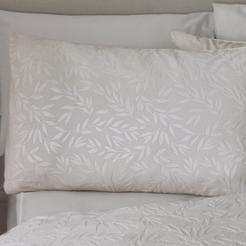 Catherine Lansfield Corded Leaves Duvet Set in Champagne Gold, showing textured leaf pattern pillowcase on a made bed