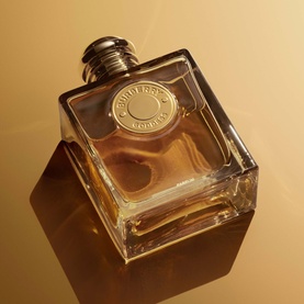 Burberry Goddess Parfum for Women 100ml EDP in square amber glass bottle with gold medallion cap on golden background
