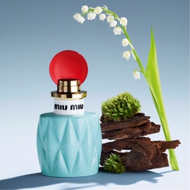 Miu Miu L'Eau de Muguet Eau de Parfum 100ml, light blue quilted bottle with red sphere cap and gold collar, styled with lily of the valley and bark