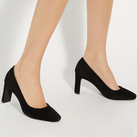 Model wearing Dune Arriving Wide Fit Court Shoes in black suede with chisel toe and high block heel