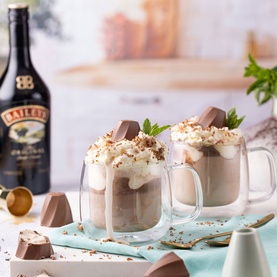 Baileys Milk Chocolate Caramel Whirls 3-Pack styled with creamy layered dessert drinks topped with whipped cream, chocolate shavings and mint