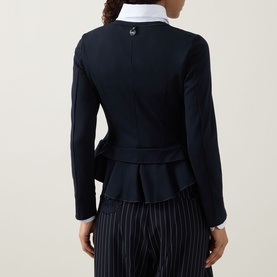 Model wearing HIGH Sapphire Pocket Jacket in navy, showing rear view with double-layered peplum hem, long sleeves, styled with white shirt and