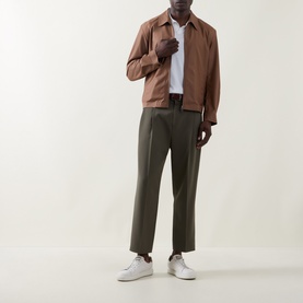 Model wearing Boss Black Casual Wing Zip Jacket in medium brown wool, styled with olive trousers and white trainers.