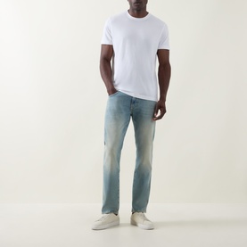 Model wearing Boss Black Casual white crew neck T-shirt, styled with light wash jeans and white trainers.