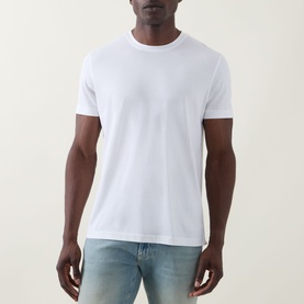 Model wearing Boss Black Casual white crew neck T-shirt in cotton-silk blend, styled with light wash jeans
