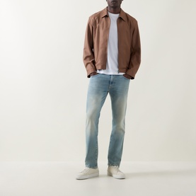 Model wearing Boss Black Casual white crew neck T-shirt, styled with brown overshirt, light wash jeans and white trainers.