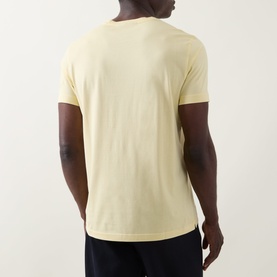 Model wearing Boss Black Casual Taut Logo T-Shirt in Beige Overflow, crew neck, short sleeves, back view, styled with dark trousers.