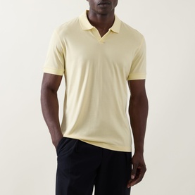 Model wearing Boss Black Casual Ponti 75 Polo Shirt in Beige Overflow, Johnny collar, short sleeves, styled with dark trousers.