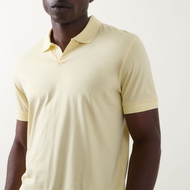 Model wearing Boss Black Casual Ponti 75 Polo Shirt in Beige Overflow, featuring a Johnny collar, short sleeves and smooth knit finish