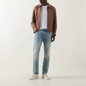 Model wearing Boss Black Casual Classic Fit Straight-Leg Jeans in light wash turquoise, styled with a brown overshirt, white tee and cream trainers.