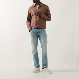 Model wearing Boss Black Casual Classic Fit Straight-Leg Jeans in turquoise/aqua light wash, styled with a brown zip jacket and white trainers.
