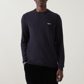 Model wearing Boss Green Label dark blue cotton crew neck knit with small chest logo, styled with black trousers