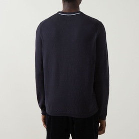 Model wearing Boss Green Label dark blue cotton crew neck jumper, rear view, with white tipping detail at collar and cuffs