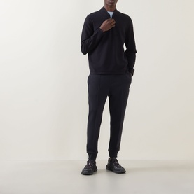 Model wearing Boss Green Label Terrace Logo Half-Zip Sweatshirt in dark blue with matching joggers and black trainers.