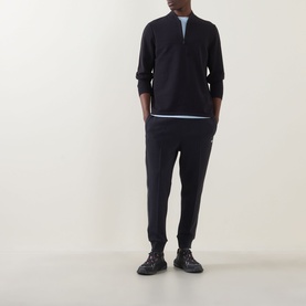 Model wearing Boss Green Label Terrace Logo Half-Zip Sweatshirt in dark blue with bomber collar, styled with navy joggers and dark trainers.