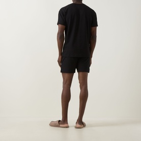 Model wearing Hugo Galaxy Shorts Pyjama Set in black, rear view showing crew neck tee and matching shorts with elasticated waistband