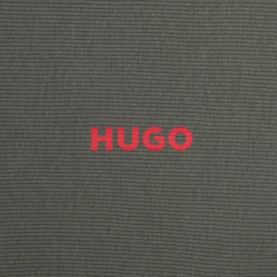 Hugo Three-Pack Solid Logo T-Shirt in khaki green, close-up of red HUGO logo on ribbed cotton fabric
