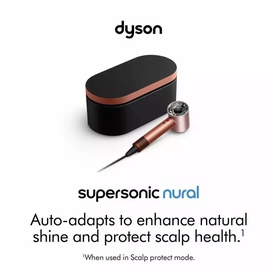 Dyson Supersonic Nural Hair Dryer in Amber Silk, shown with black and copper travel case on white background