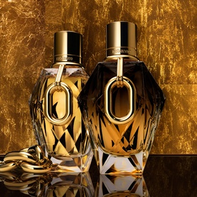 RABANNE Million Gold For Her Parfum 50ml, two faceted dark glass bottles with gold caps against a golden textured background