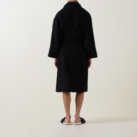 Model wearing Paul Smith Access Zebra Logo Robe in black, rear view, shawl collar, belted wrap style, paired with zebra-print slippers
