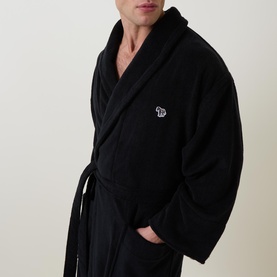 Model wearing Paul Smith Access Zebra Logo Robe in black, showing shawl collar, wrap front, and embroidered zebra logo badge detail