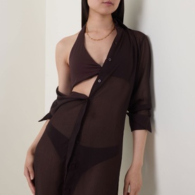 Model wearing Jets chocolate bikini top styled with sheer brown shirt dress and gold necklace