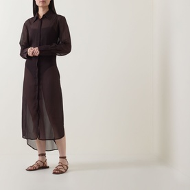 Model wearing Jets Belted Beach Shirt Dress in Chocolate, sheer long-sleeve midi with button front and high-low hem, styled with flat tan sandals