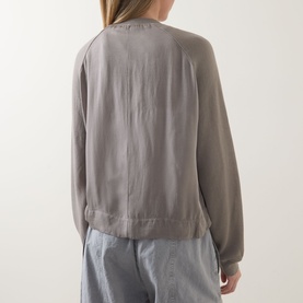 Model wearing Transit Patch Pocket Cardigan in Rope, back view, long sleeves and straight hem, styled with light blue jeans