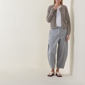 Model wearing Transit Patch Pocket Cardigan in Rope with white tee, grey striped barrel-leg trousers and black sandals.