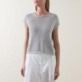 Model wearing Transit Open-Knit Sweater in light grey with round neck and cap sleeves, styled with white wide-leg trousers.