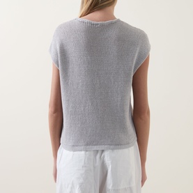 Model wearing Transit Open-Knit Sweater in light grey, cap sleeves, ribbed trim, open-knit construction, back view, styled with white trousers