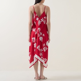 Model wearing Seafolly Mayflower Scarf Dress in Cosmo Red, back view showing floral print, spaghetti straps, and handkerchief hemline with contrast