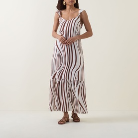 Model wearing Seafolly Striped Tiered Dress in Cocoa, maxi length with wide knotted straps, tiered skirt, styled with tan sandals