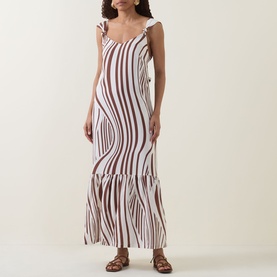 Model wearing Seafolly Striped Tiered Dress in Cocoa, maxi length with knotted straps, tiered skirt and wavy stripe print, styled with tan sandals.