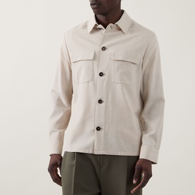 Model wearing Slowear Silk Flap Pocket Overshirt in stone, featuring point collar, two chest flap pockets and front button fastening, styled with
