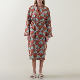 Model wearing Their Nibs Turning Tides Grandpa Dressing Gown in Clams, coral and sage cotton robe with shawl collar and self-tie belt, styled with