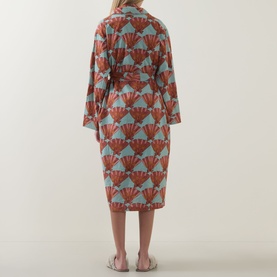 Model wearing Their Nibs Turning Tides Grandpa Dressing Gown in Clams, showing back view with self-tie belt and fan-print cotton fabric