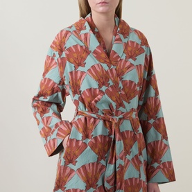 Model wearing Their Nibs Turning Tides Grandpa Dressing Gown in Clams, featuring shawl collar, self-tie belt and fan print in terracotta and sage