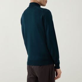 Model wearing John Smedley Tapton Extra Fine Knit Half-Zip Sweater in Richardson green, shown from behind with dark trousers.