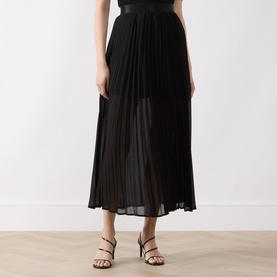 Model wearing Selected Femme Millie Pliss&eacute; Pleated Skirt in black, midi length with pliss&eacute; pleating and high-rise waist, styled with strappy heeled