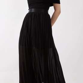 Model wearing Selected Femme Millie Pliss&eacute; Pleated Skirt in black, midi length with sheer pleated panels and leather-look waistband, styled with