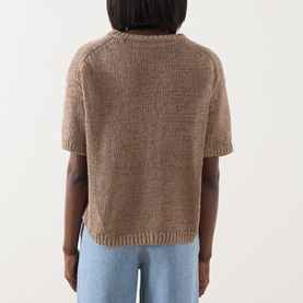 Model wearing Marc O Polo Solid Knit Top in taupe, rear view, short sleeves, crew neck, ribbed hem, styled with light blue jeans.