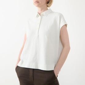 Model wearing Marc O Polo Textured Polo Shirt in light grey, featuring polo collar, cap sleeves and straight hem, styled with dark trousers