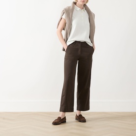 Model wearing Marc O Polo Textured Polo Shirt in Light Grey with brown wide-leg trousers and brown loafers.