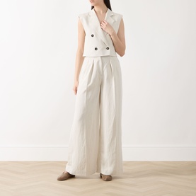 Model wearing Marc O Polo Double-Breasted Cropped Waistcoat in beige, styled with wide-leg trousers and flat loafers.