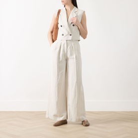 Model wearing Marc O Polo Beige Double-Breasted Cropped Waistcoat with wide-leg trousers, styled with tan bag and taupe mules