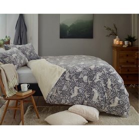 Deyongs Woodland Folk Fleece Duvet Set in grey with cream sherpa reverse, featuring hare and floral print, styled on a double bed