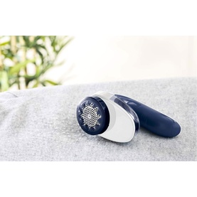 Tefal Fabric Shaver in blue and white, shown on grey fabric with circular shaving head visible
