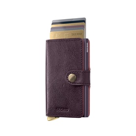 Secrid Basco Ink Leather Miniwallet in burgundy with gunmetal-tone button closure and silver-tone card ejector mechanism, fanned cards visible
